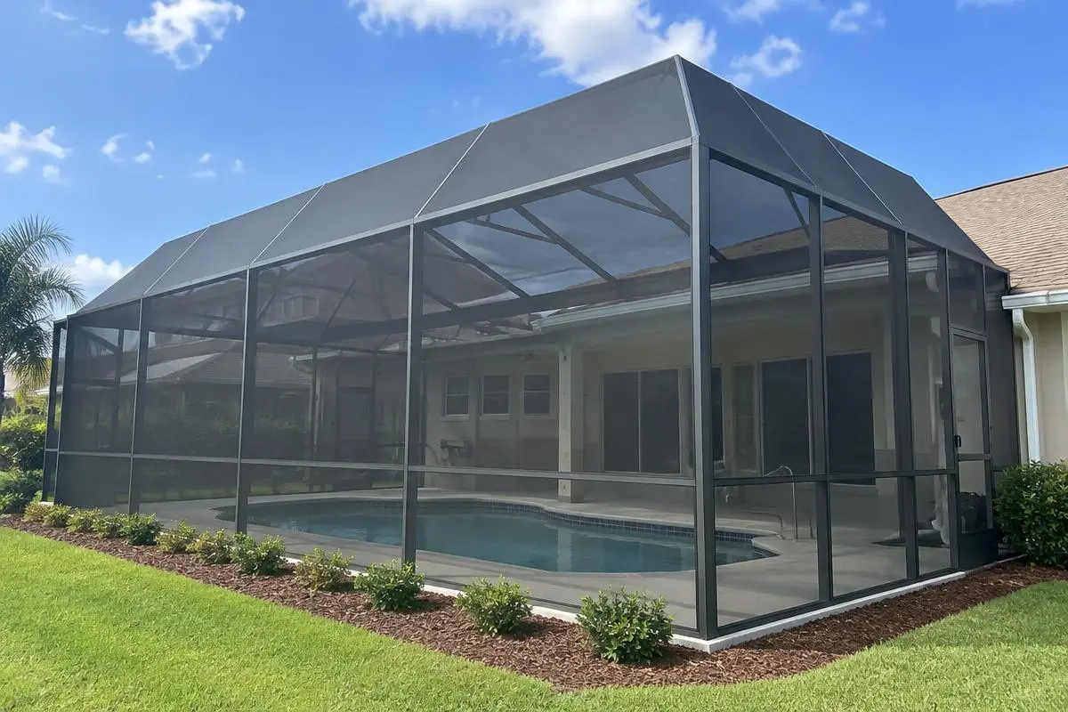 Dark mesh screen enclosure around a backyard pool